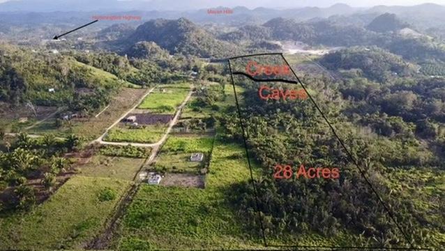 28 acres at the entrance to Agua Viva, minute from Hummingbird highway, With creek and cave